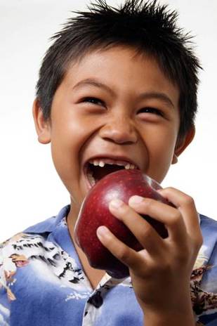 Young Boy About to Take a Big Bite Out of an Apple
