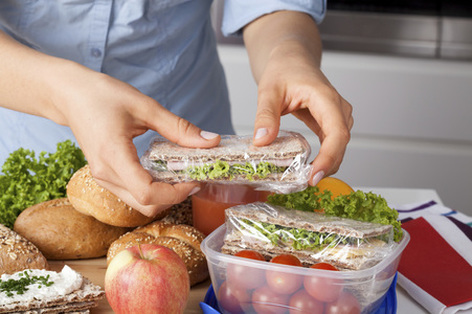 Volunteer Packing a Healthy Three Food Group Lunch